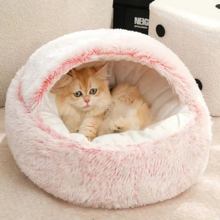 Kitten comfortably burrowing inside the pink and white Dogegis® calming nest bed