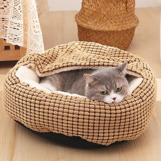 A gray cat resting inside a brown corduroy "Taco" or "Pocket" style cave bed, demonstrating the flexible, blanket-like hood that characterizes the Burrower category of pet beds