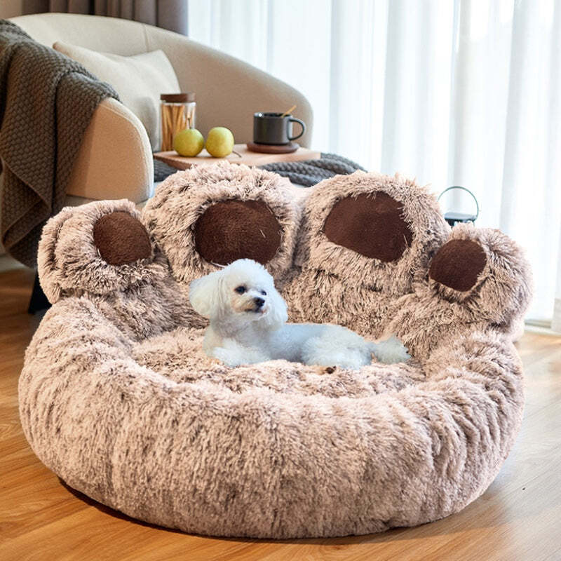 Brown paw-shaped Dogegis™ calming dog bed offering orthopedic joint support and a secure den-like feel.