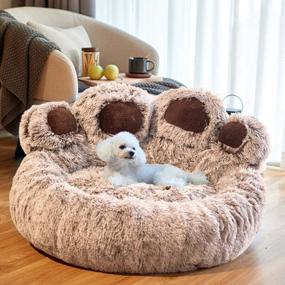 Brown paw-shaped Dogegis™ calming dog bed offering orthopedic joint support and a secure den-like feel.