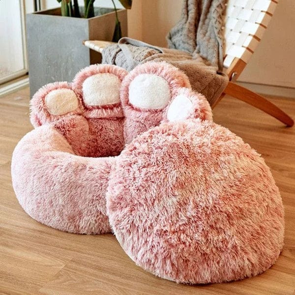Pink paw-shaped Dogegis™ calming dog bed showcasing its plush structure and removable cushion.