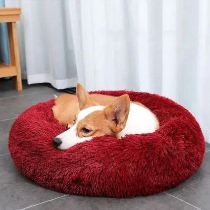 Red Dogegis™ calming donut dog bed showcasing its vibrant color and plush supportive rim.