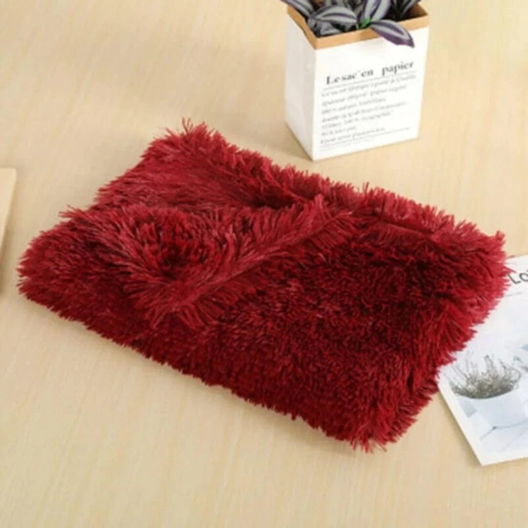 Red Dogegis™ Calming Pet Blanket laid flat, showcasing its plush faux fur and furniture-protecting design