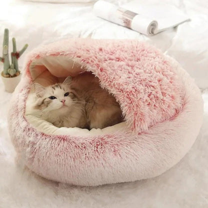 A cat enjoying the warmth and security of the pink Dogegis® CozyNook cave bed